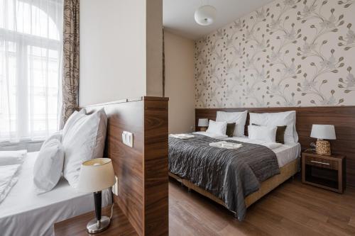 a bedroom with a bed and a wall at Elit Boutique Rooms- Best Location by BQA in Budapest