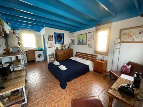 a bedroom with a bed and a blue ceiling at MP Cozy Apartment Near the Sea in Paphos City