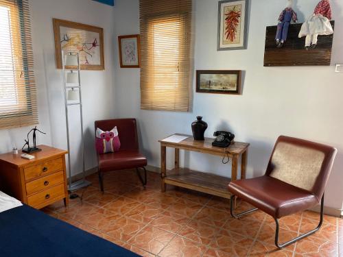 a bedroom with two chairs and a table and a bed at MP Cozy Apartment Near the Sea in Paphos City