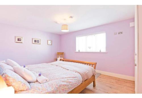 a bedroom with a bed with a pig pillow on it at Modern Homestay 15 minutes to Dublin Airport in Ballyboughal
