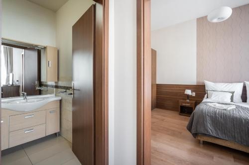 a bathroom with a bed and a sink at Elit Boutique Rooms- Best Location by BQA in Budapest