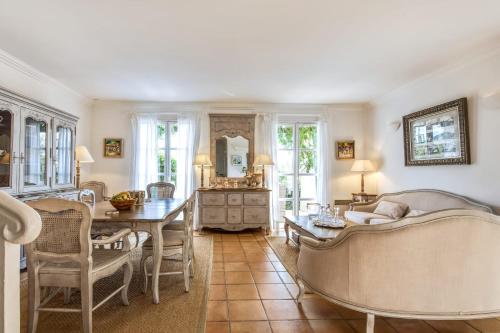 un salon avec une table et une salle à manger dans l'établissement Villa Belle Époque - Welkeys, à Grimaud