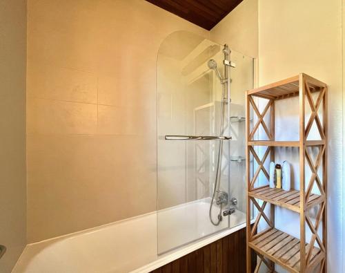 a shower with a glass door in a bathroom at La bergerie d'Egat: Chalet authentique avec vue in Égat