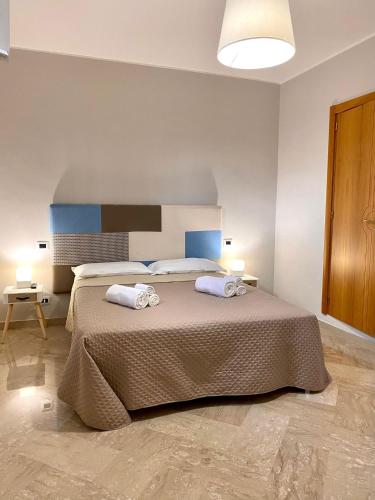 Ένα ή περισσότερα κρεβάτια σε δωμάτιο στο Ginevra Rooms