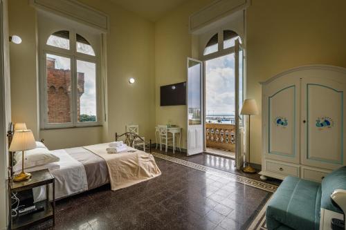 a hotel room with a bed and a balcony at Onlyrooms IV - Sea View & Free Parking in Cagliari