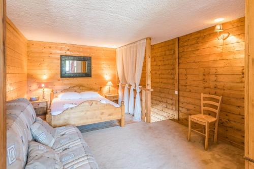 a bedroom with a bed and a chair at Charming apartment with view on the Mont Blanc - Welkeys in Megève