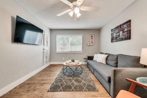 a living room with a couch and a flat screen tv at Global Cup The Eastside Flat Arboretum Tickets Included in Dallas