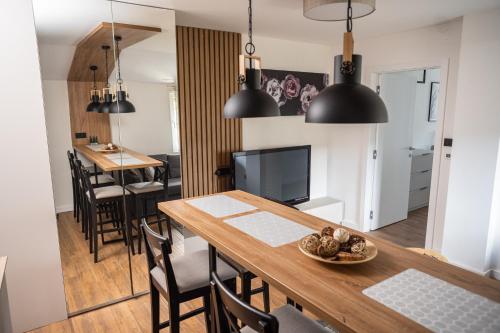 a kitchen and dining room with a table and chairs at Mountain Chalet Kopaonik in Kopaonik