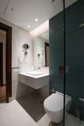 a bathroom with a toilet and a sink and a shower at New Cairo, Akoya Residence, Milena in New cairo