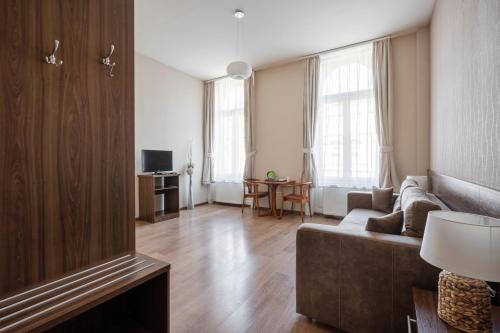 a living room with a couch and a table at Elit Boutique Rooms- Best Location by BQA in Budapest