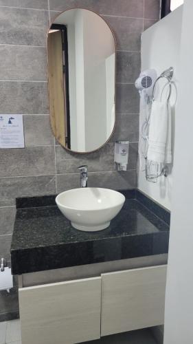 a bathroom with a sink and a mirror at Hotel Piedras De Maní in Manizales
