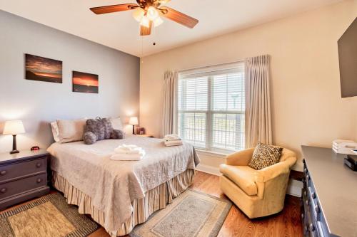 a bedroom with a bed and a chair and a window at Nelton's Nest 815 #201DS-H in Hatteras