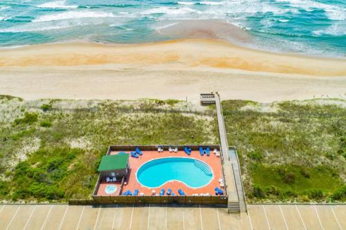 an overhead view of a swimming pool next to the beach at Nelton's Nest 815 #201DS-H in Hatteras