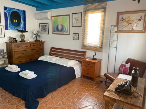 a bedroom with a bed and a chair and a table at MP Cozy Apartment Near the Sea in Paphos City