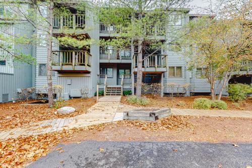 a building with a yard with leaves on the ground at South Beach 53 in Glen Arbor