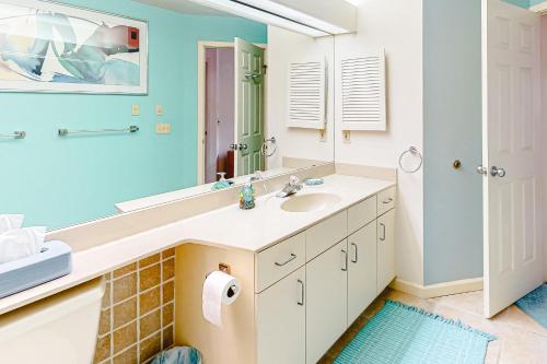a bathroom with a sink and a mirror at South Beach 53 in Glen Arbor