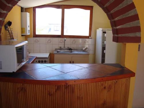 a kitchen with a counter top with a microwave at casa norma santiago 5 personas in Santiago