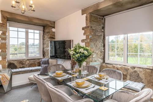 a dining room with a table and chairs at Bridge End Mill by Guestz in Settle