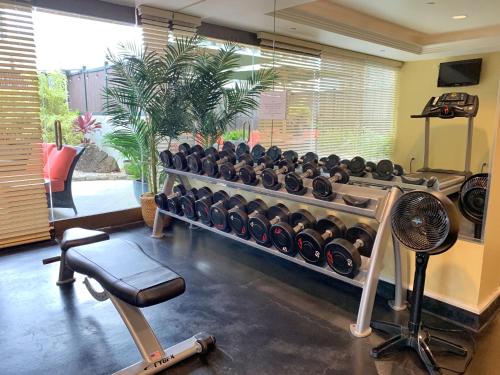 a gym with a rack of dumbbells and a fan at Vacation Rental Studios at Royal Garden Waikiki in Honolulu