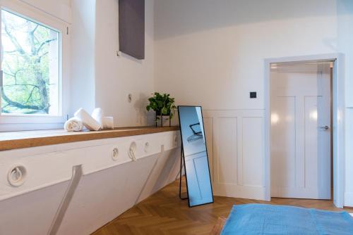 a kitchen with a sink and a window and a mirror at Design Loft I 130 qm I Europapark 20min I 2 Etagen I 2 Bäder I Nespresso I Parkplatz in Lahr