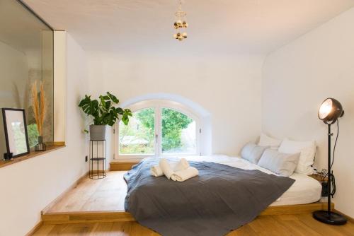 a bedroom with a large bed with a window at Design Loft I 130 qm I Europapark 20min I 2 Etagen I 2 Bäder I Nespresso I Parkplatz in Lahr