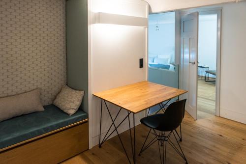 a small room with a desk and a bed and a chair at Design Loft I 130 qm I Europapark 20min I 2 Etagen I 2 Bäder I Nespresso I Parkplatz in Lahr