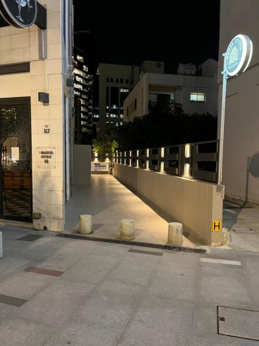 a city street at night with a building and a sign at Angel Suites in Nicosia