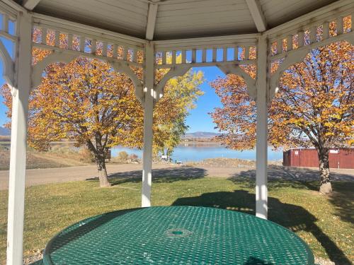 a table in a gazebo with a view of a lake at Family-friendly Home on Boyd Lake, Gorgeous Views! in Loveland