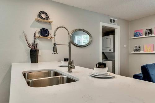 a kitchen with a sink and a counter at The Brilliant Flat Arboretum Tickets Included in Dallas