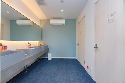 La salle de bains est pourvue de 2 lavabos et d'un miroir. dans l'établissement OKAYAMA GLAMPING SORANIA - Vacation STAY 20221v, à Kurashiki