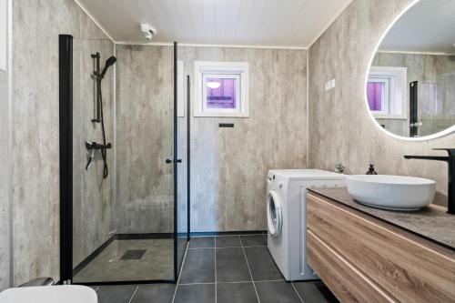 y baño con lavabo y lavadora. en Finnvika Lodges, en Stamsund