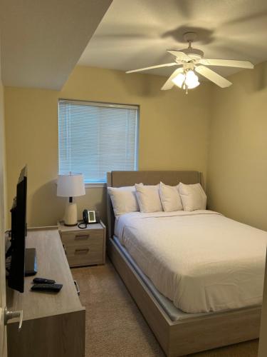 a bedroom with a bed and a ceiling fan at WASHBURN HOTEL SUITES in Topeka