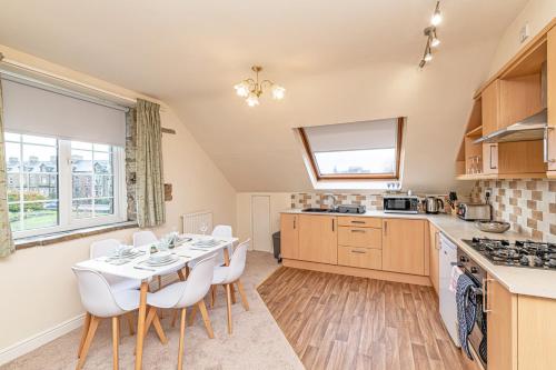a kitchen and dining room with a table and chairs at Bridge End Mill by Guestz in Settle