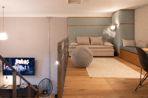 a living room with a couch and a tv at Design Loft I 130 qm I 22 min zum Europapark I 2 Etagen I Nespresso I Parkplatz in Lahr
