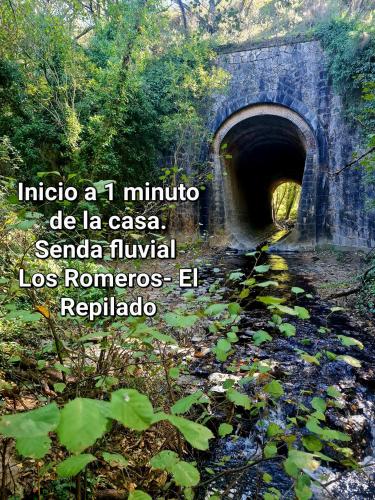 a bridge over a river with a quote about a tunnel at La Casa Junto al Sendero del Río & Piscina # aire acondicionado in Los Romeros