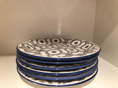 a stack of blue and white plates sitting on a table at Hogar Dulce Hogar in Mar de Ajó