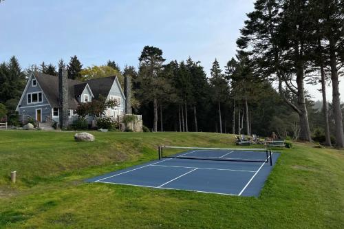 a tennis court on a hill with a house at Trinidad Pearl in Trinidad