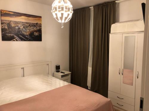 1 dormitorio con cama y lámpara de araña en Green 44 Central Bucharest Universitate, en Bucarest