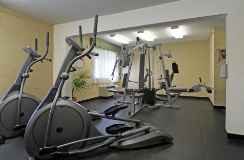 a gym with several tread machines in a room at Maple Tree Inn in Sunnyvale