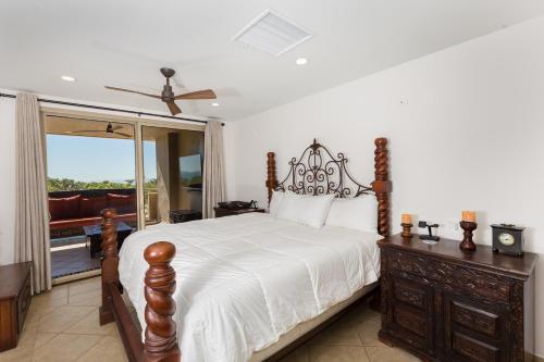 a bedroom with a large bed and a balcony at Bella Sirena 201-C in Puerto Peñasco