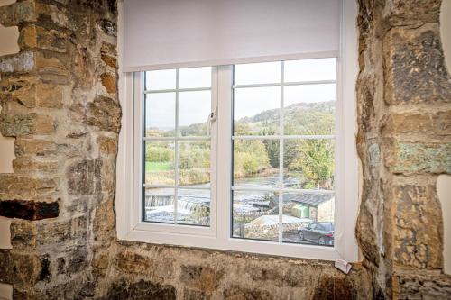 a window in a room with a view at Bridge End Mill by Guestz in Settle