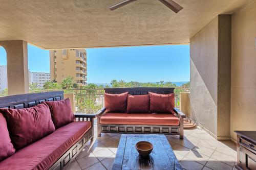 a balcony with a couch and a table at Bella Sirena Beauty 201-C - Stunning Views & Beachfront Bliss in Puerto Peñasco