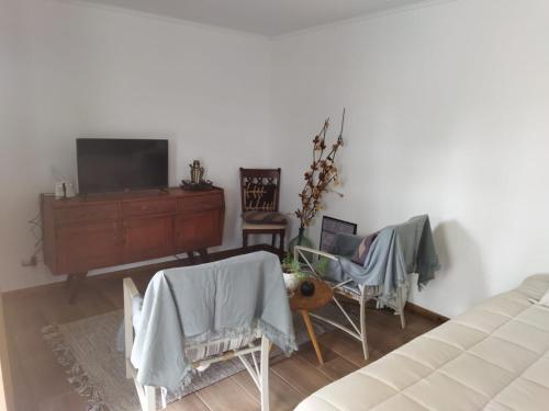 a bedroom with a tv and a table and chairs at Container home in Santa Teresa de Lo Ovalle