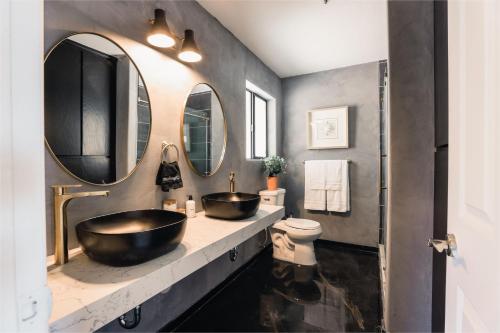 a bathroom with two sinks and two mirrors at @ Marbella Lane - Zen-like Ambiance 3BR Home in JT in Joshua Tree