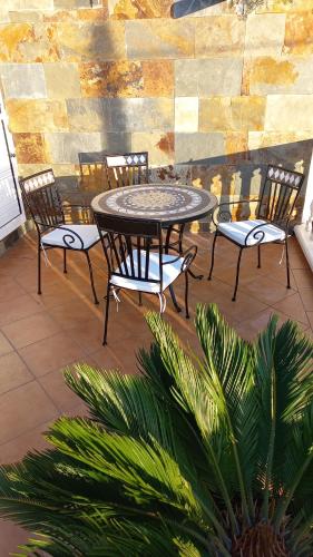 a table and chairs sitting on a patio at Casa sol y montaña in Cubaba