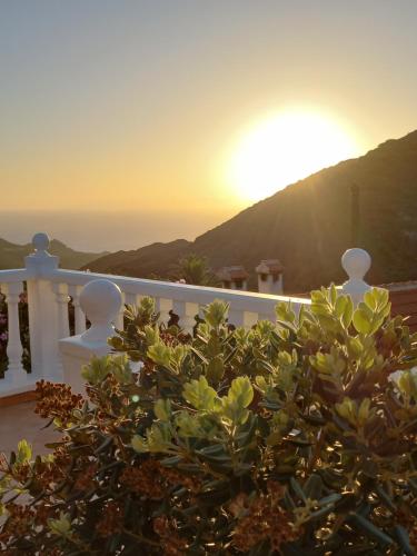 a view of the sunset from the balcony of a house at Casa sol y montaña in Cubaba