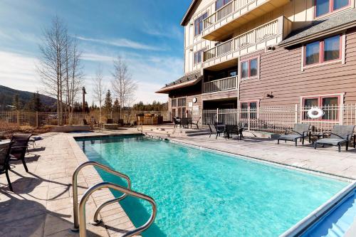 a swimming pool with chairs next to a building at Red Hawk Lodge 2200 in Dillon