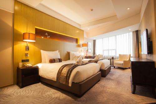 Posteľ alebo postele v izbe v ubytovaní Xian heng Hotel