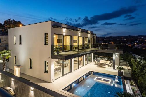 a large white house with a swimming pool at Villa Titanium in Opatija