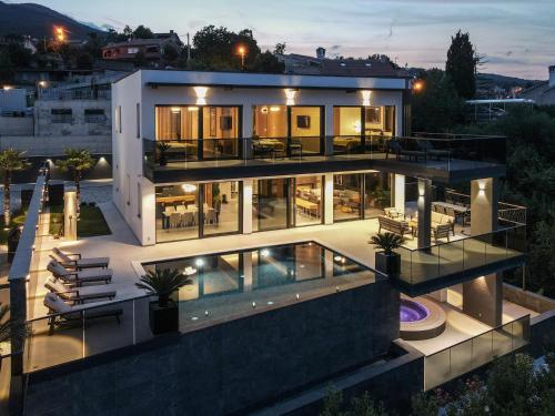 a large house with a pool at night at Villa Titanium in Opatija